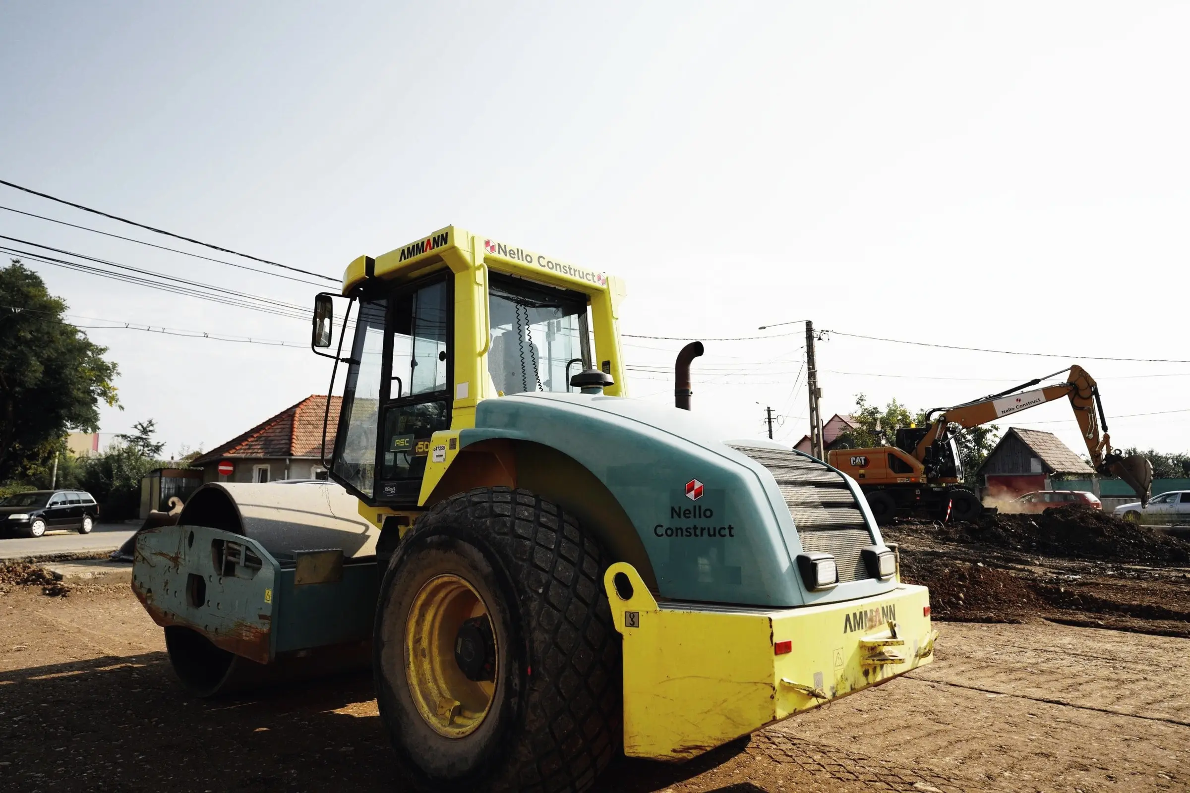 Compactor cu tambur vibrant Nello Construct pe un șantier cu pământ afânat